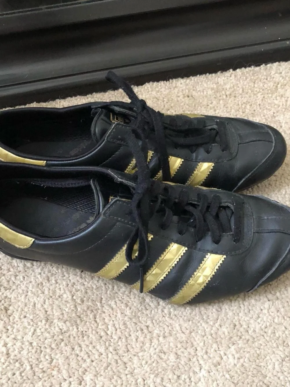 adidas Women’s Black Sneakers with Gold Stripes